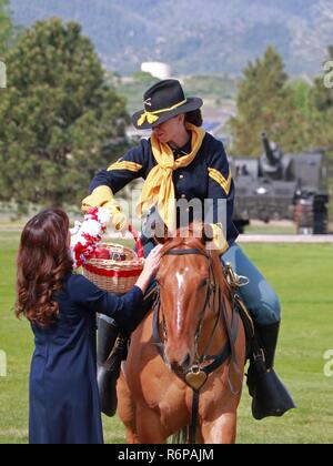 Kim Garman Händen einen Korb mit Äpfeln an SPC. Herbst Eachlr, Fort Carson montiert Farbe Schutz, während die Evans Armee Community Hospital Ändern des Befehls Zeremonie 22. Mai an Gründer. Während der Zeremonie, Oberst Patrick M. Garman seinen Befehl zu oberst Eric S. Edwards aufgegeben. Kim Garman wurde auch mit der Abteilung der Armee hervorragende Zivildienst Award für ihre Arbeit mit Tumbleweeds am Berg Post anerkannt, ein Zentrum für künstlerischen und kreativen Bemühungen. Stockfoto