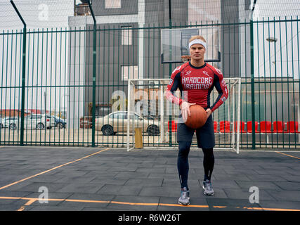 Basketball Spieler spielt auf der Straße Stockfoto