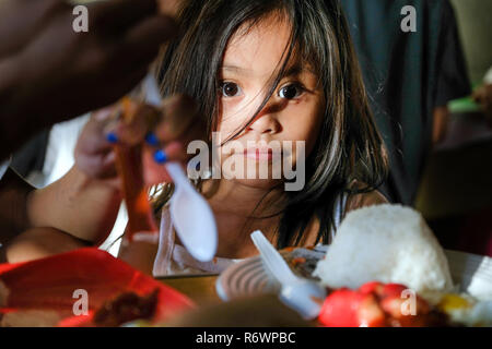 Straßenkinder in Quezon City (Metro Manila) werden durch Kuya Zentrum Sozialarbeiter für eine Mahlzeit in einer Snack Bar eingeladen. Auf den Philippinen. Stockfoto