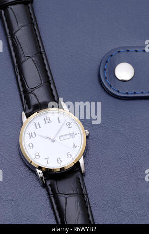 Armbanduhr mit Lederband auf Business-notebook Stockfoto