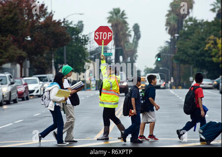 Crossing Guard mit Schulkindern Stockfoto