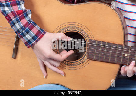 Nahaufnahmen der Hände ist eine junge Frau, die Gitarre spielen Stockfoto