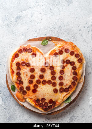 Pepperoni Pizza in Herzform und Papa Wort Stockfoto