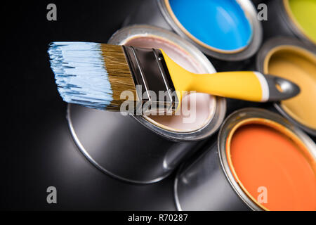 Blechdosen mit Farbe und Pinsel Stockfoto