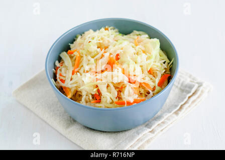 Von oben geschossen von Schüssel mit leckerem Sauerkraut auf Stück Stoff auf weißem Hintergrund Stockfoto