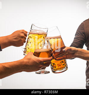 Hände mit Becher Bier toasten erstellen Splash auf weißem Hintergrund Stockfoto