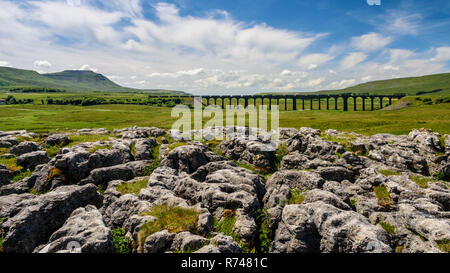 Ribblehead, England, Großbritannien - 3. Juli 2015: ein Zug von Frachtcontainern kreuzt die Ribblehead Viadukt auf der malerischen Vereinbaren und Carlisle Railway in Engl Stockfoto