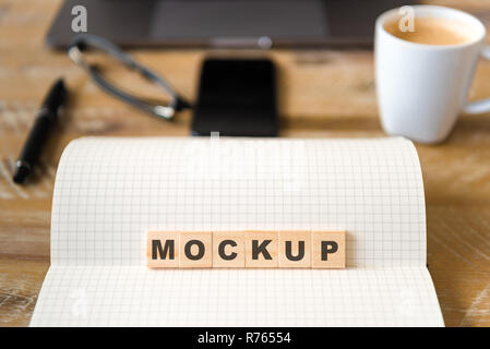 Nahaufnahme auf das Notebook um Holz Tisch Hintergrund, auf Holzblöcken mit Buchstaben, Mockup Text konzentrieren Stockfoto