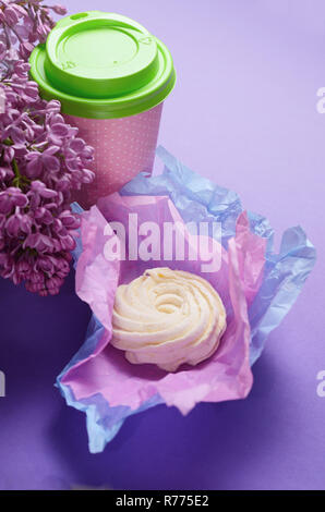 Essen Foto von hausgemachten Zephyr, Eibisch in violett Geschenkpapier und Kaffee Tasse zu gehen. Süße Nachspeise auf einem rosa Hintergrund. Stockfoto