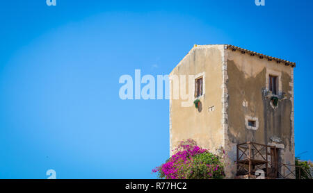 Sizilien, Italien. Altes Haus mit lila Blüten in Syrakus. Stockfoto