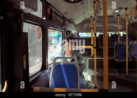 Passagier Reisende am Fenster in Bus suchen, man Touristen sitzen im Bus Stockfoto