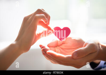 Frau mit Herz auf der Hand Stockfoto