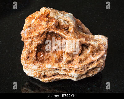 Wulfenit Kristalle auf rauen Felsen auf Schwarz Stockfoto