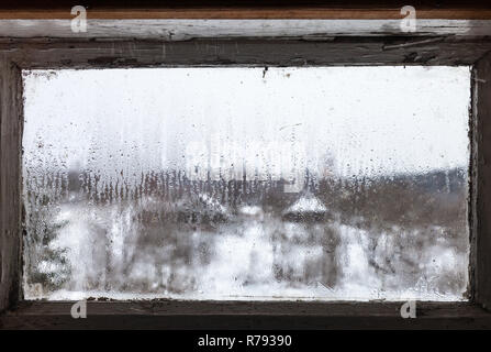 Wassertropfen von schmilzt das Eis auf dem zugefrorenen Fenster Stockfoto