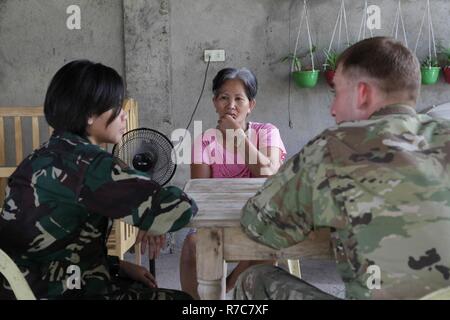 Philippinische Armee 1. Lt Yvone S. Ricaforte, Links, und der US-Army Staff Sgt. Keeton Tucker Familie überleben und Evakuierungspläne für potenzielle Naturkatastrophen mit Einheimischen von Baranguy Popolon, Neuenkirchen, Stadt, 12. Mai 2017 als Teil der Balikatan 2017 diskutieren. Balikatan ist eine jährliche US-Philippinischen bilaterale militärische Übung auf einer Vielzahl von Missionen, einschließlich humanitärer Hilfe und Katastrophenhilfe, Terrorismusbekämpfung und andere kombinierte militärische Operationen ausgerichtet. Stockfoto