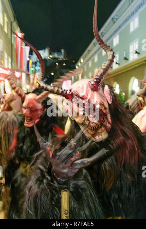 Salzburg: Krampuslauf (Krampus-Lauf, Perchtenlauf, Krampus, Maske Prozession) in der Altstadt in der Straße, in der hofstallgasse zurück Burg Hohensalzburg Stockfoto