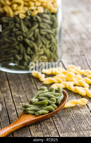 Nicht gegartem Spinat gemelli Pasta in Löffel aus Holz. Stockfoto