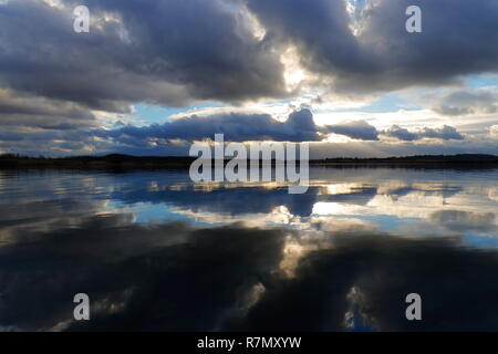 Fast ein Spiegelbild des Cloud Reflexionen über den See an St. Aidan's Country Park in Leeds Stockfoto