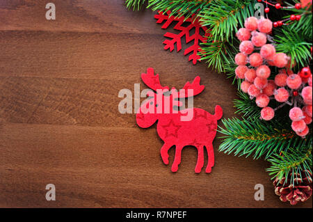 Weihnachten Figur Elch und Zweige auf einen hölzernen Hintergrund Fichte Stockfoto