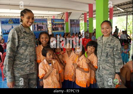 Us Air Force Piloten First Class Shalyn Griffin (links) und Havika Farro posieren für ein Foto mit Studenten von Ban Tanod Poonpol Witthaya Schule, Provinz Nakhon Ratchasima, während der Übung bewältigen Tiger 17 (CT 17) Kombinierte staatsbürgerlichen Engagements Engagement in Thailand, 22. März 2017. Die Kombination des staatsbürgerlichen Engagements Engagement bietet eine Steckdose für die Länder in der CT 17 teilnehmenden zurück zu der Gemeinschaft Umgebung Korat Royal Thai Air Force Base zu geben. Flieger mit der 44Th Fighter Squadron, 44 Aircraft Maintenance Unit, 18 Aircraft Maintenance Squadron und 961St Airborne Air Control Squadron von Kad Stockfoto