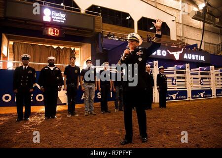 AUSTIN, Texas (22. März 2017) Kapitän Cassidy Norman, Executive Officer der Flugzeugträger USS Harry S. Truman (CVN 75), grüßt die Menschenmenge vor Abgabe der Eid der Anwerbung der künftigen Segler im Austin Rodeo während Marine Woche Austin. Marine Woche Programme dienen als wichtigste übertreffen Bemühung der Marine in den Bereichen des Landes ohne eine bedeutende Marine Präsenz. Stockfoto