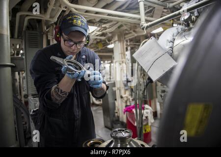 KINBU BAY (27. März 2017) Engineman 3. Klasse Scotty Engelhard, von Lake St. Louis, MO., arbeitet an einem schmieröl Luftreiniger im Maschinenraum an Bord des amphibious Transport dock USS Green Bay LPD (20). Green Bay, Teil der Bonhomme Richard Expeditionary Strike Group, mit 31 Marine Expeditionary Unit begonnen, ist auf einer Routinepatrouille in der Indo-Asia - Pazifik Region warfighting Bereitschaft und Haltung als ready-Response Force für jede Art der Kontingenz zu verbessern. Stockfoto