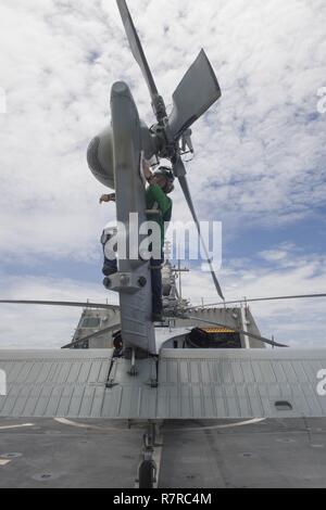 Straße von Malakka (30. März 2017) Aviation Machinist Mate 2. Klasse Jordanien Kriedler, von Rom Ga. wischt sie den Schwanz von einem MH-60S Seahawk Hubschrauber vor dem Flug Viertel an Bord Littoral Combat Ship USS Coronado (LCS 4). Die derzeit auf einen Rotationsfehler Bereitstellung in USA 7 Flotte Verantwortungsbereich, Coronado ist ein schnelles und agiles Kriegsschiff maßgeschneidert auf Patrouille in der Region und die Arbeit littorals Hull - Hull mit Partner Seestreitkräfte, die siebte Flotte mit der flexiblen Möglichkeiten es heute und in Zukunft braucht. Stockfoto