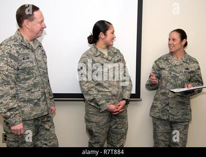 Command Chief Master Sgt. Patricia Hickey, rechts, und Oberst Mark Wilson, individuelle Mobilisierung Augmentee auf die 66Th Air Base Group Commander, präsentieren sie ein Zertifikat zu Airman 1st Class Michele Anderson, 66th Comptroller Squadron Support Mitarbeiter, auf Ihre Förderung durch die Below-the-Zone. BTZ ist eine wettbewerbsfähige frühen Förderung zu denjenigen in den Rang eines airman First Class angeboten. Auch gefördert wurde Airman 1st Class John Miller, ein Streifenpolizist auf die 66Th Sicherheitskräfte Geschwader zugewiesen. Stockfoto