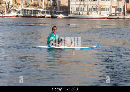 Assuan, Ägypten - September 13, 2018: Ägyptische Zicklein in einem Surf Board im Nil. Stockfoto