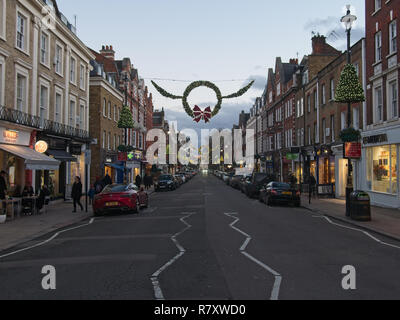 London, England/Großbritannien - 12. Dezember 2018: St John's Wood Hight Street mit Weihnachtsdekoration in den Abend. Stockfoto