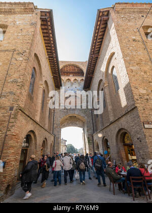 Vertikale Ansicht von Touristen im Tor von San Gimignano, Italien. Stockfoto