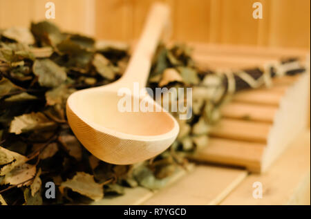 Sauna Zubehör schließen, die mit traditionellen finnischen oder russische Sauna, Birke, Besen und Schaufel aus Holz. Ruhe und Entspannung im Spa im kalten Winter warm zu halten Stockfoto