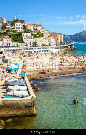 Menschen mit Sonnenbaden und Schwimmen auf der Prophet Strand in Marseille, einem sehr beliebten Strand auf dem Kennedy Corniche entfernt, an einem sonnigen Frühlingstag. Stockfoto