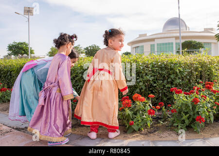 Kleine Mädchen tragen Kostüme von gefrorenen Prinzessin Elsa, Sofia, und Anna roaming Das flower garden Stockfoto