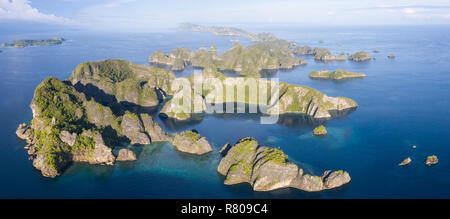 Flachen Korallenriffen umgeben remote Kalkstein Inseln in Raja Ampat, Indonesien. Diese artenreichen Region wird als das "Herz der Korallen Dreieck bekannt." Stockfoto