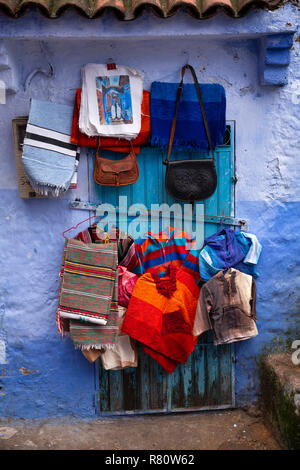 Marokko, Fes, blaue Stadt, Souvenir Textil shop Anzeige der gewebte Bekleidung und Lederwaren zum Verkauf Stockfoto