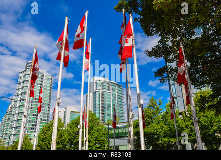 Kanadische Fahnen. Vancouver BC Wolkenkratzer im Hintergrund an einem schönen Tag mit blauem Himmel Stockfoto