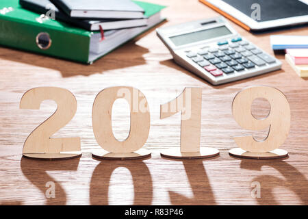 2019 Datum der Sperrholz Zahlen mit Schatten auf Holz- büro Schreibtisch gemacht Stockfoto