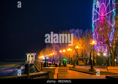 Riesenrad am Ufer des Amur in Chabarowsk gegen den Nachthimmel. Eine helle Beleuchtung. An der langen Belichtung fotografiert. Stockfoto