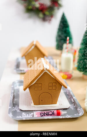 Kinder Partei kleine Lebkuchenhäuser mit Bonbons zu verzieren. Stockfoto