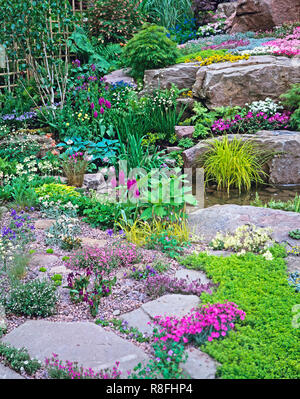 Bunte alpine Steingarten und Wasserfall für ein Land, Garten Stockfoto