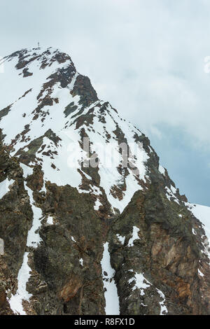 Juni Blick von der Karlesjoch Alpen Berg (3108 m, in der Nähe der Kaunertal Gletscher auf Austria-Italy Grenze) über den Abgrund und Wolken. Stockfoto