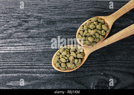 Ginseng trocken Tee auf schwarzem Holz Hintergrund Stockfoto