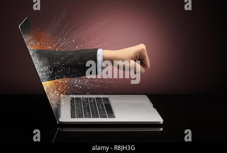 Hand, die aus einem Laptop mit funkelnden Effekten Stockfoto