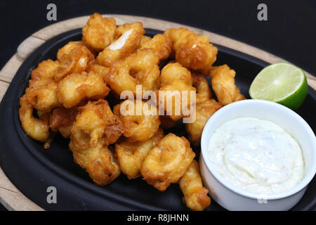 Knusprig gebratener tempura Calamares mit Sauce Tartar und Kalk Stockfoto