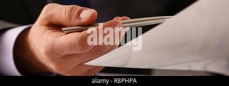 Männliche Hand in Anzug halten siver Pen im Büro Stockfoto