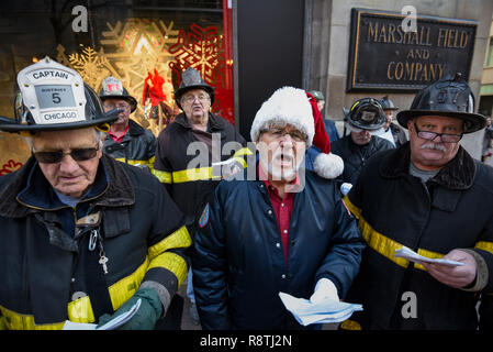 Chicago, USA. 17. Dezember 2018. Chicago Feuerwehrmänner, außerhalb Macy's Flagship Store an der alten Marshall Fields Gebäude an der State Street, singen Weihnachtslieder, Geld für die lokale Heilsarmee Liebe zu erhöhen. Credit: Stephen Chung/Alamy leben Nachrichten Stockfoto