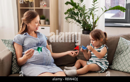 Schwangere Mutter und Tochter mit Kran origami Stockfoto