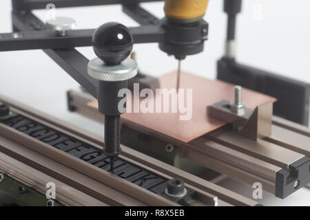 Gravur Gerät Stromabnehmer mit CNC-graveur mit Buchdruck Alphabet auf weißem Hintergrund Stockfoto