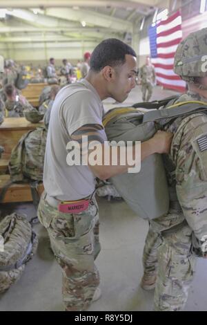 Staff Sgt, José Marrero, Rädern, Mechaniker, Fallschirmjäger und springen Master für die Zentrale und Hauptverwaltung Battalion, 82nd Airborne Division, führt einen Sprung master Personal überprüfung auf der Fallschirmjäger in Pack drei Schuppen an der Grünen Rampe auf Papst Army in Fort Bragg, NC, 28.02.2017. Marrero sagte, daß die beste Teil seines Jobs führt, Soldaten und die Ausbildung von Soldaten; er liebt, was er tut, und das ist der Grund, warum Er dient Stockfoto